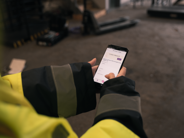 Worker looking at app on phone